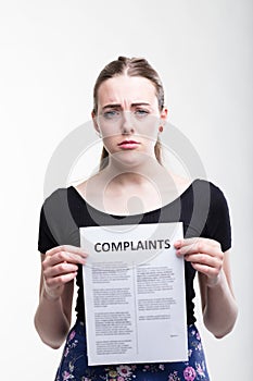 Sad woman holding up a list of complaints