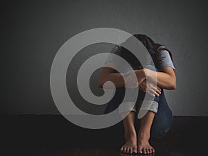 Sad woman hug her knee and cry.