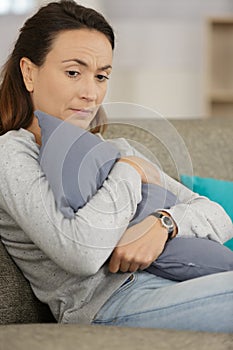 sad woman hugging pillow