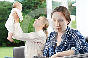 Sad Woman Jealous Of Friend With Young Baby