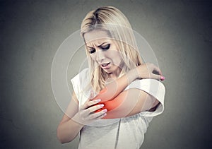 Sad woman with joint inflammation. Female`s elbow. Arm pain and injury. photo