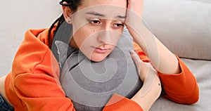 Sad woman leaning on hand with eyes closed