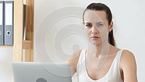 Sad Woman Looking at Camera at Work in Office photo