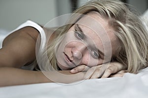 Sad woman lying in bed depressed