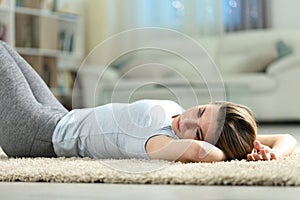 Sad woman lying discouraged at home photo