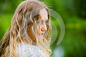 Sad young fashion woman with long curly hairs outdoor photo