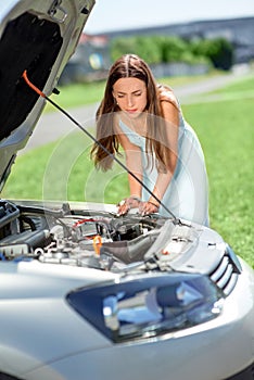 Sad woman near the broken car