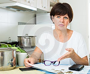 Sad woman paying bills