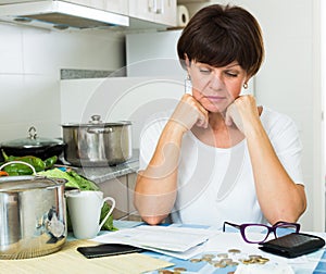 Sad woman paying bills