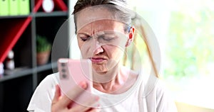 Sad woman with poor eyesight looking at mobile phone screen 4k movie slow motion