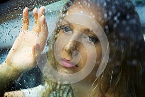 Sad woman and a rain