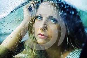 Triste una mujer en auto en la lluvia 