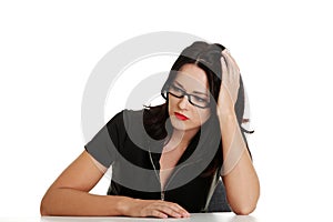 Sad woman sitting behind the desk