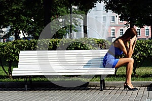 Sad woman sitting on bench