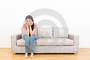 Sad woman sitting on the couch and weeping crying