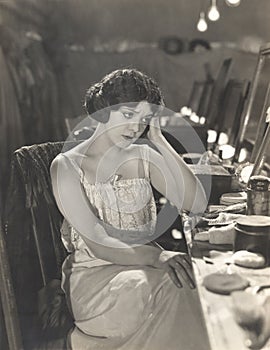 Sad woman sitting in dressing room