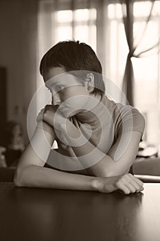 Sad woman sitting with hands clasped