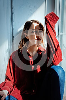 Sad woman sitting near window and shadows
