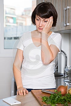 Sad woman tired of worries at kitchen