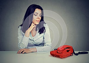 Sad woman waiting for someone to call her