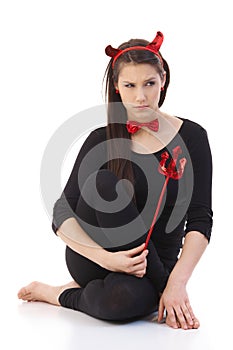 Sad woman wearing devil costume