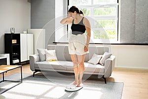 Sad Woman On Weight Scale After Diet