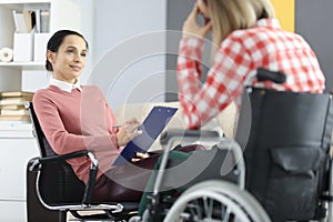 Sad woman in wheelchair at the reception of psychologist