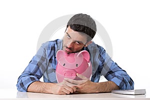 Sad worried man in stress with empty piggy bank