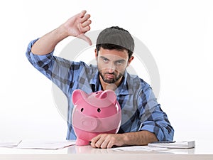 Sad worried man in stress with piggy bank in bad f