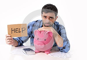 Sad worried man in stress with piggy bank in bad financial situation