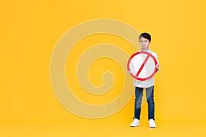 Sad young Asian boy holding red ban signage photo