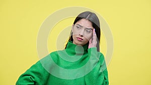Sad Young Caucasian Woman Pondering Over Yellow Background