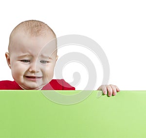 Sad young child holding shield