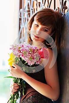 Sad young fashion woman with a flowers