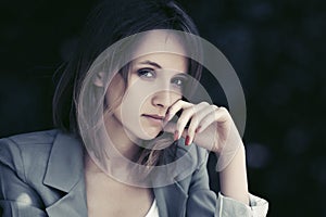 Sad young fashion woman in gray blazer photo