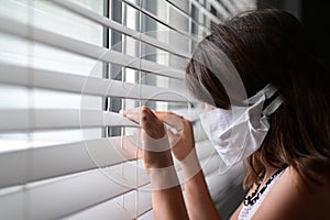 Sad young girl forced to stay at home as the pandemic coronavirus