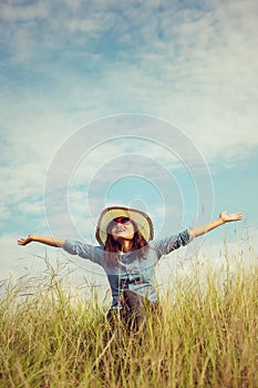 Sad young girl sitting alone on a grass outdoors,Sadness. Loneliness