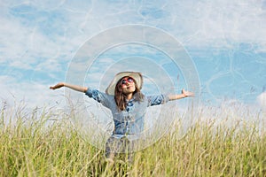 Sad young girl sitting alone on a grass outdoors,Sadness. Loneliness