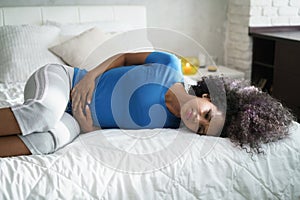 Beautiful Hispanic Girl Feeling Pain During Period photo