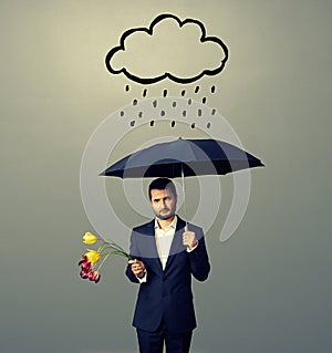 Sad young man with black umbrella