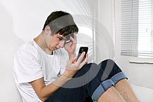 Sad Young Man with Cellphone