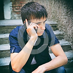 Sad Young Man with Cellphone