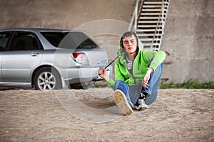 Sad young man in depression sitting on the ground