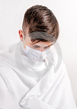 Sad Young Man in a Flu Mask