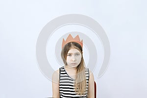 Sad young teenager girl in red crown