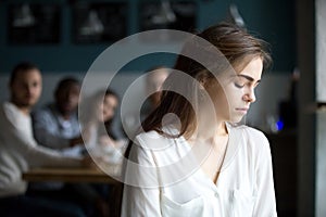 Sad young woman avoiding friends suffering from gossiping or bul