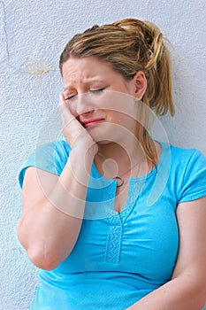 Sad young woman crying alone.