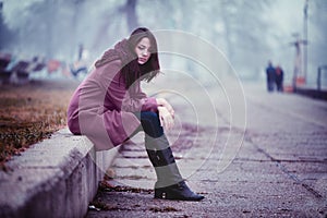 Sad Young Woman in Depression Sitting Outdoors