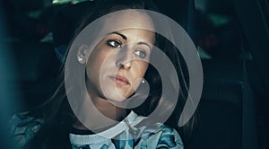 Sad young woman girl crying sitting inside of car photo