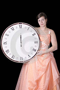 Sad young woman in gown holding a midnight clock